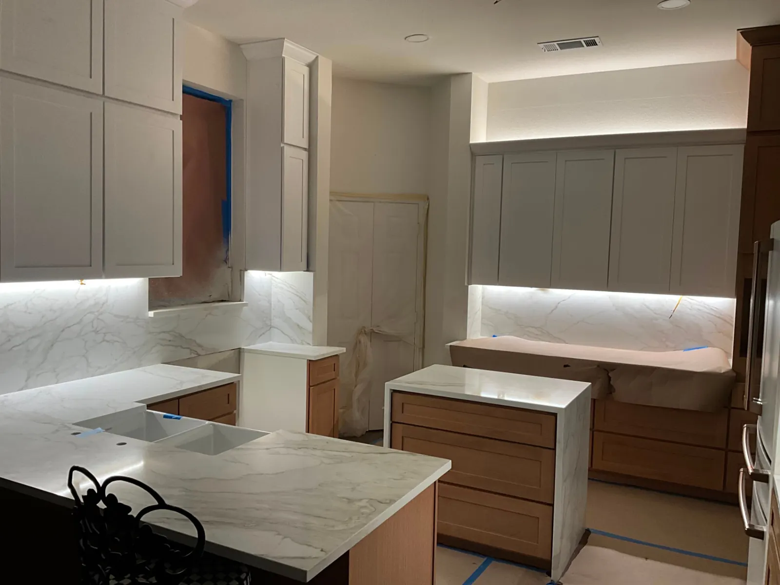 Dallas kitchen remodel in progress with marble countertops, under-cabinet lighting, and new cabinetry