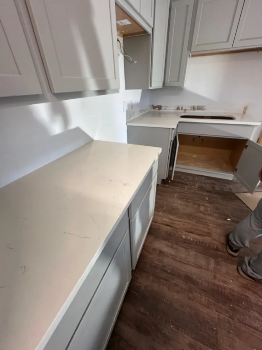 Fresh quartz countertop installed on new gray cabinets in Seward