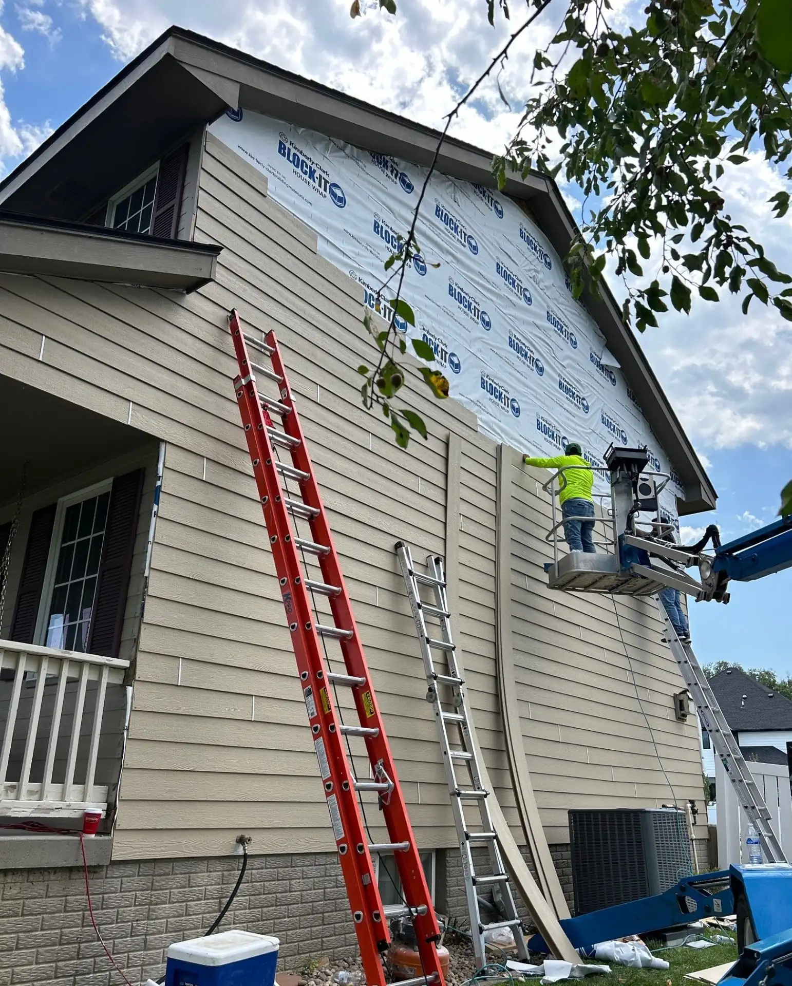Highland Remodeling crew installing new siding and house wrap on a Dallas home