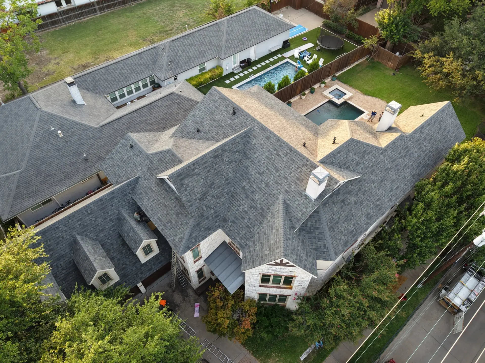 Aerial view of a recently replaced residential roof in a Dallas neighborhood